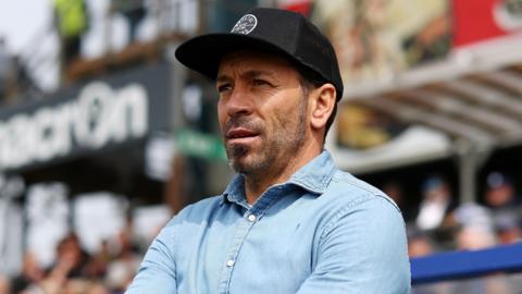 Inigo Calderon standing next to the dugout during a Bristol Rovers match