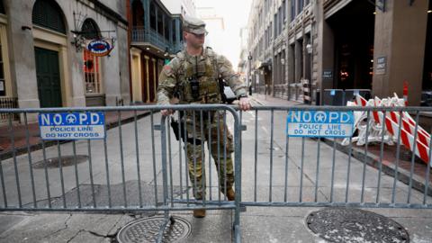 A member of the National Guard Military Police stands, in the area where people were killed by a man driving a truck in an attack during New Year's celebrations, in New Orleans