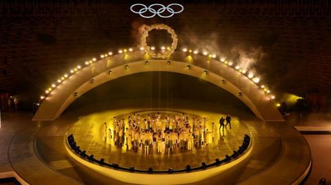 Winter Olympics closing ceremony, with performers and Olympic rings