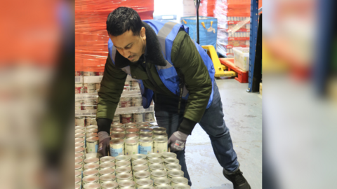 Abdulla Almamun stacking canned food