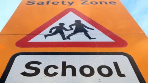 General view of a school safety zone sign