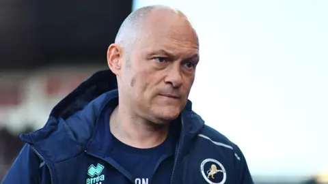 Millwall boss Alex Neil looks on