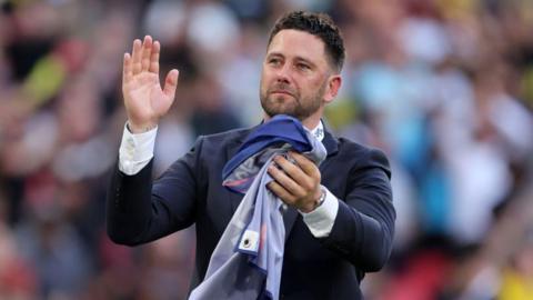 Des Buckingham celebrates at Wembley following their victory in the League One play-off final