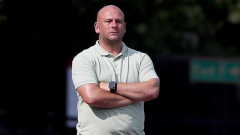 Adam Murray with arms folded