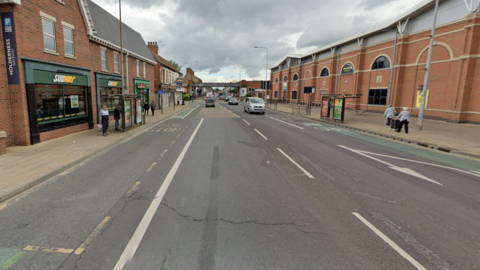 A Google Street View screen capture of Holderness Road in Hull, on a strect between Mount Pleasant and Burleigh Street. The poor state of the road surface can be seen with cracks, potholes and uneven surfaces.