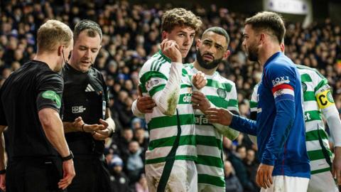 Celtic's Arne Engels (centre) was hit by a coin late in the Old Firm game