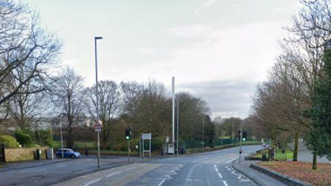 A blue mini waits to turn onto a deserted Eccles Old Road