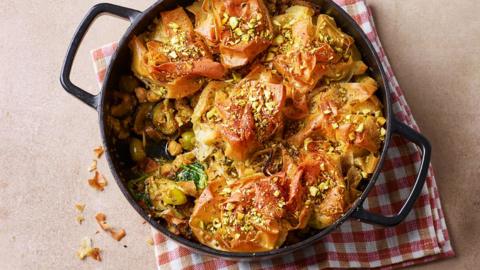A pan filled with courgette, pistachio and olive filo pie.