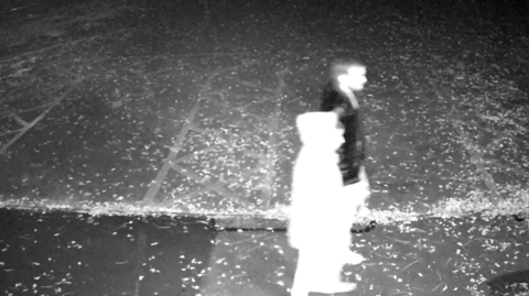 CCTV of two people walking at night. 