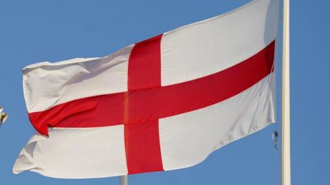 The St George's flag - a red cross on a white background - flies from a flag pole