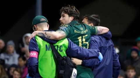 Mack Hansen is carried from the field