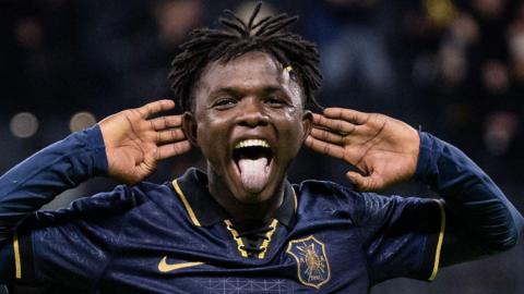Zadok Yohanna cups both ears in celebration and sticks his tongue after scoring for AIK Stockholm
