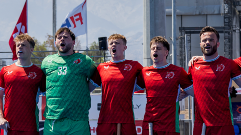 Wales line up for the anthem ahead of the pushback in Santiago, Chile.