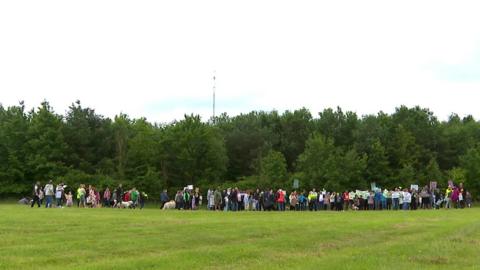 Group of people in a field holding a protest