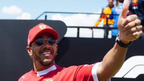 Lewis Hamilton gives a thumbs-up while smiling at the Ferrari 'tifosi' before Sunday's Emilia-Romagna Grand Prix