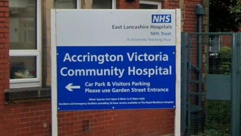 Close up image of a sign in white writing on blue saying Accrington Victoria Community Hospital