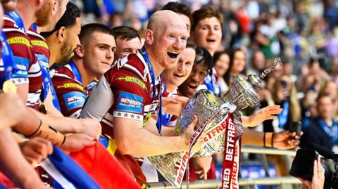 Wigan Warriors captain Liam Farrell holds the Challenge Cup trophy after their win against Warrington Wolves in the 2024 final