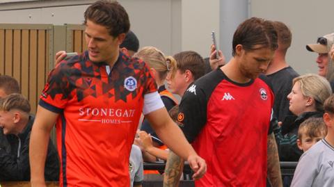 Dorking and Truro players walk out for their match