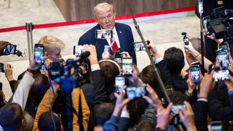 Donald Trump surrounded by reporters at Davos