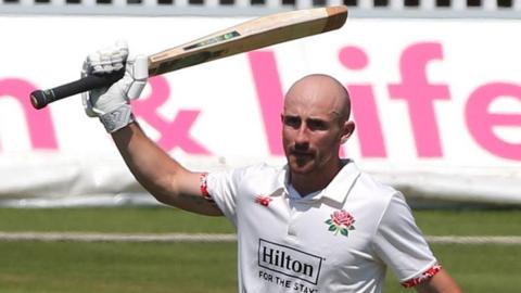 Josh Bohannon raises his bat to celebrate reaching 200 