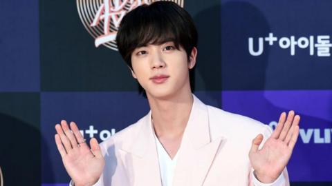 Jin of BTS waves at cameras as he arrives at the photo call for the 34th Golden Disc Awards on January 05, 2020 in Seoul