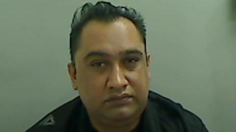 Mugshot of Chaudrhy. He is clean-shaven and has short black hair.