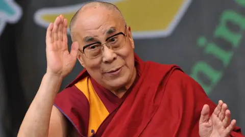 His holiness the Dalai Lama joins Patti Smith on the Pyramid stage during the third day of Glastonbury Festival at Worthy Farm, Pilton on June 28, 2015 in Glastonbury, England. 