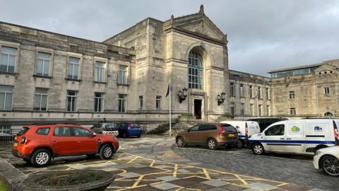 The headquarters of Southampton City Council - a large building built from pale stone with a car park in front of it