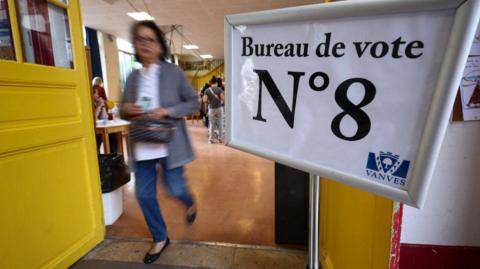 woman walks out of polling station