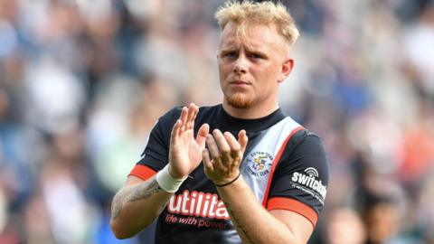 Joe Taylor applauds Luton Town supporters