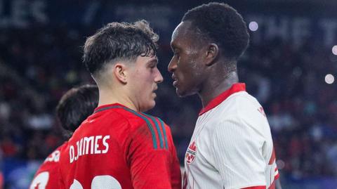 Wales' Daniel James (L) squares up to Richie Laryea of Canada