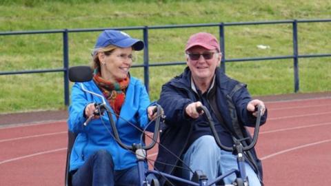 Two people riding a bike