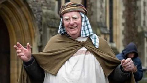 Shepherd in a living nativity scene in St Albans