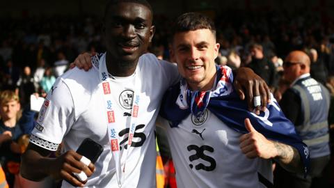 Mitchell Clark on the right celebrates Port Vale's promotion to League One with team-mate Jesse Debrah
