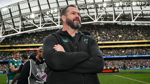 Andy Farrell stands with his arms folded inside Aviva Stadium, wearing an Ireland team fleece top