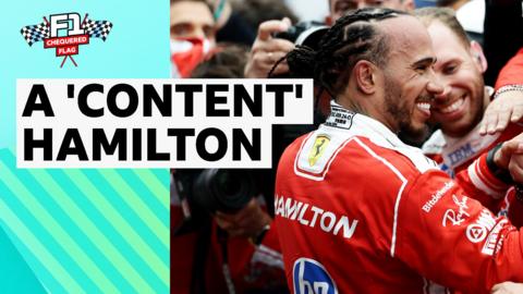 Lewis Hamilton smiling in Ferrari race suit 