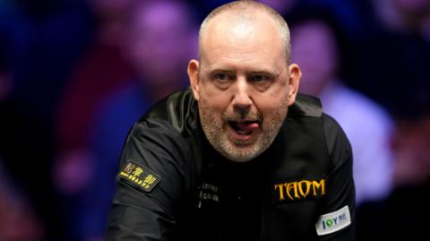 Mark Williams reacts after playing a shot against David Gilbert,