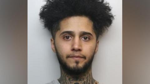 A mugshot of Harwe.