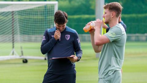 Andoni Iraola looking at his pre-season notes