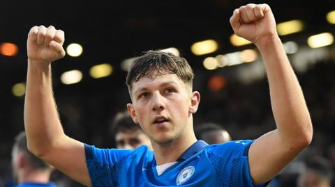 Harry Leonard raises both fists to celebrate one of his goals for Peterborough United in their 2-1 win over Northampton Town