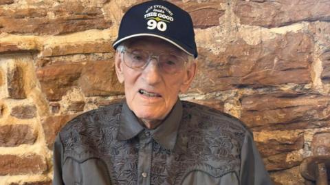 Derek Poole, 91, from Selston, Nottinghamshire, wearing a cap and shirt.