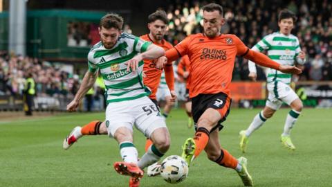 Celtic's Anthony Ralston and Dundee United's Vicko Sevelj in action 