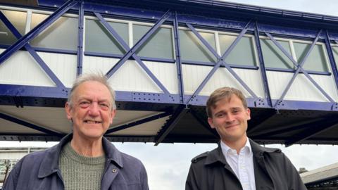 Terry French, from Selby and District Rail Users' Group, and Selby's Labour MP Keir Mather, in front of the restored and strengthened Grade II listed footbridge at Selby Railway Station