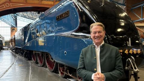 Michael Portillo stands in front of the Mallard