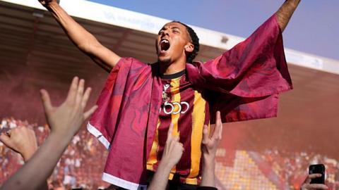 Romoney Crichlow celebrates with Bradford City fans after the Bantams earned promotion to League One