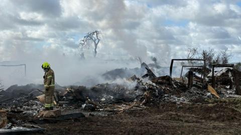 Nottinghamshire Fire and Rescue Service remain at the scene on Tuesday 21 April 2026 at Hathernware Industrial Estate, in Sutton Bonington, after a fire started on 15 April 2026.
