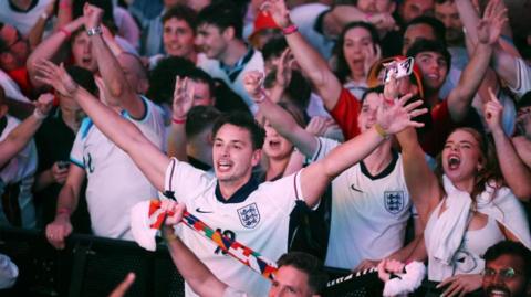 England supporters celebrate their team's victory