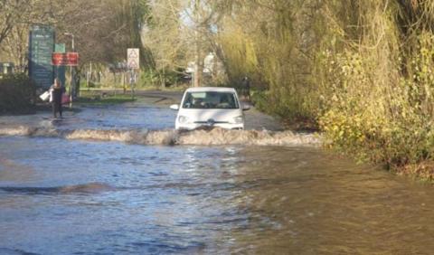 Car driving through flooded road