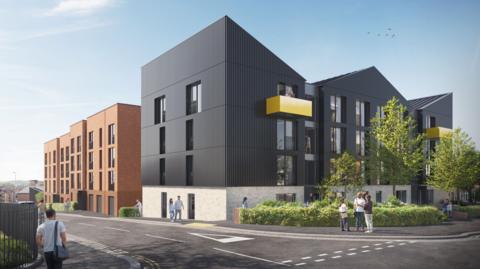 An artist's visualisation of a housing development. There are angular black buildings viewed from a road junction with give way markings. Features on the black buildings include two yellow-banded balconies either side and a number of windows. The structures have pointed roofs, and there is a further brick building in the distance.