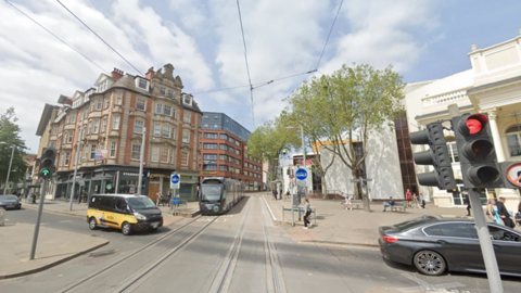 A tram at the stop on Goldsmith Street near Theatre Royal in Nottingham city centre